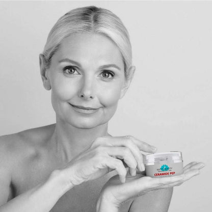 Woman holding a jar of Ceramide Pep cream against a plain background